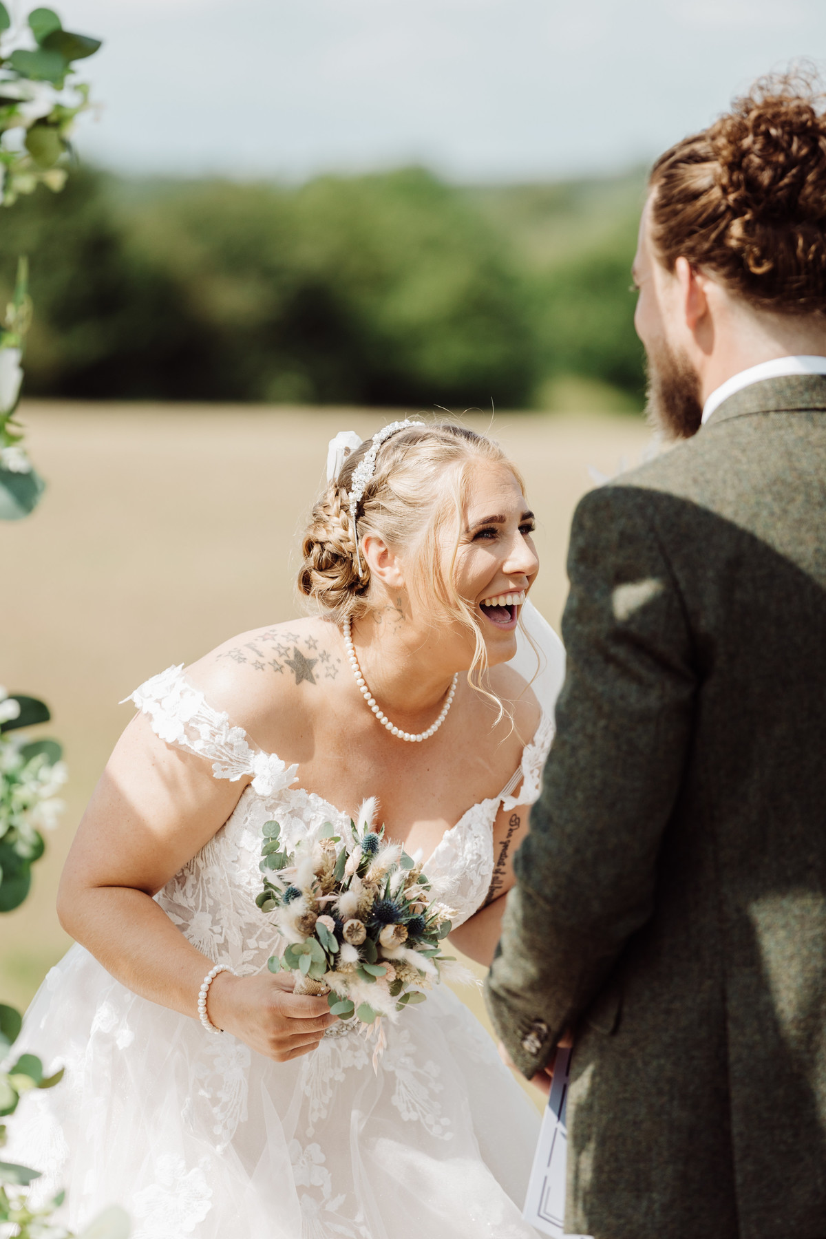 Natural laughs from the bride during her farm wedding ceremony