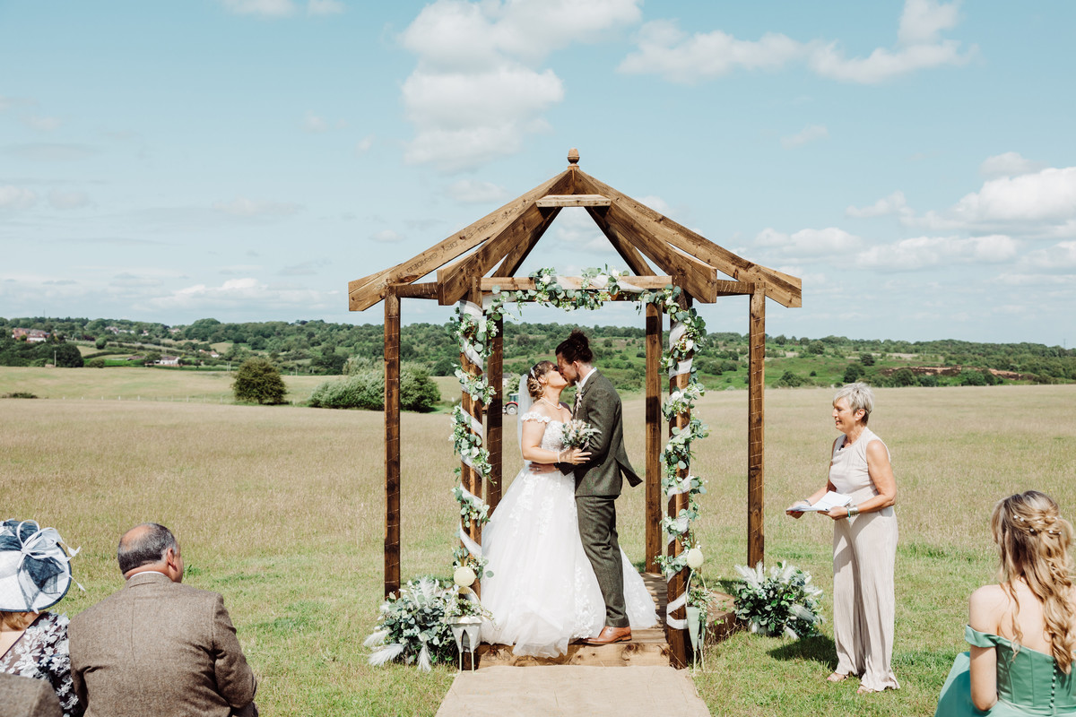 Bride and Groom first kiss at their Staffordshire farm wedding