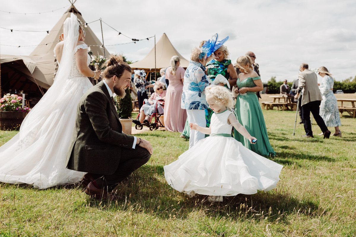 Proud dad and flower girl daughter at a tipi wedding in Staffordshire
