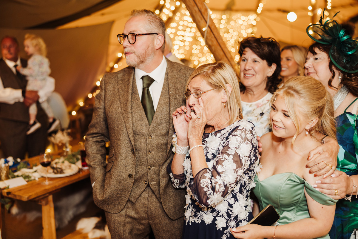 Mother of the bride sheds a tear watching father daughter dance in tipi wedding