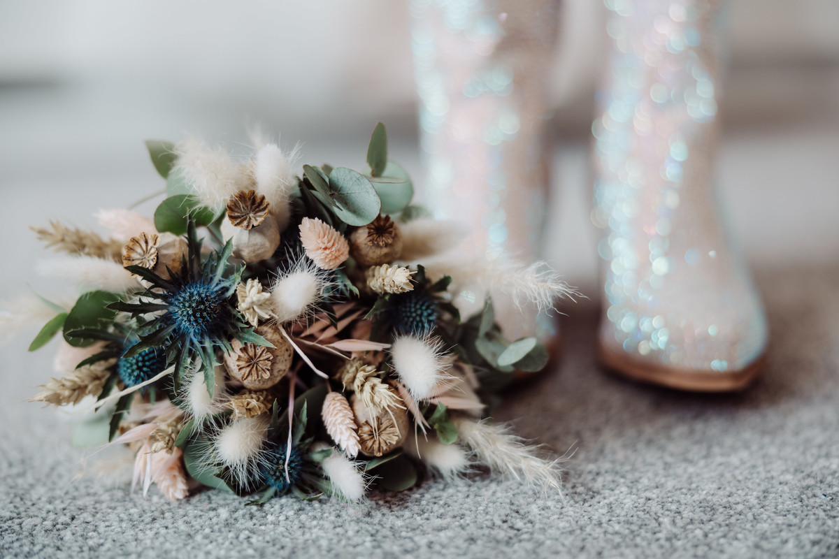 Brides flowers and rhinestone crystal cowboy boots at a Staffordshire Farm wedding
