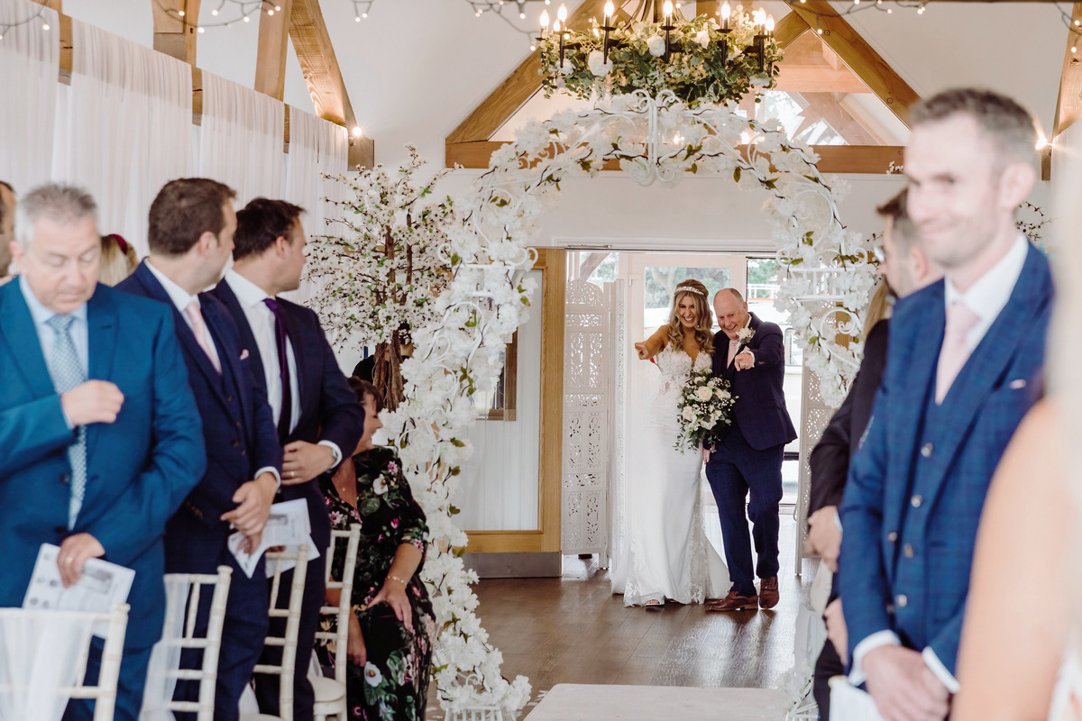 Bride seeing the cardboard cutout of Domino during her Blithfield Lakeside Barns wedding ceremony