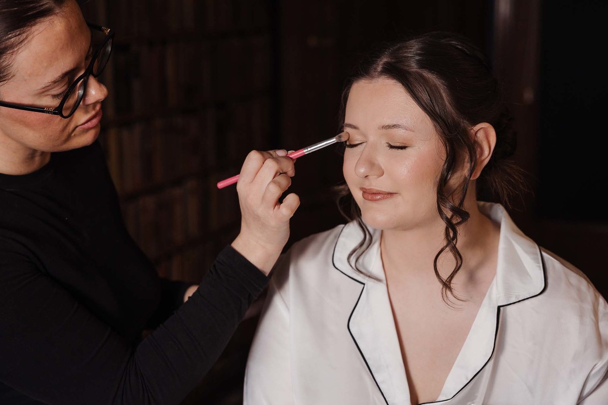Bride having make up done in the library at The Moat House
