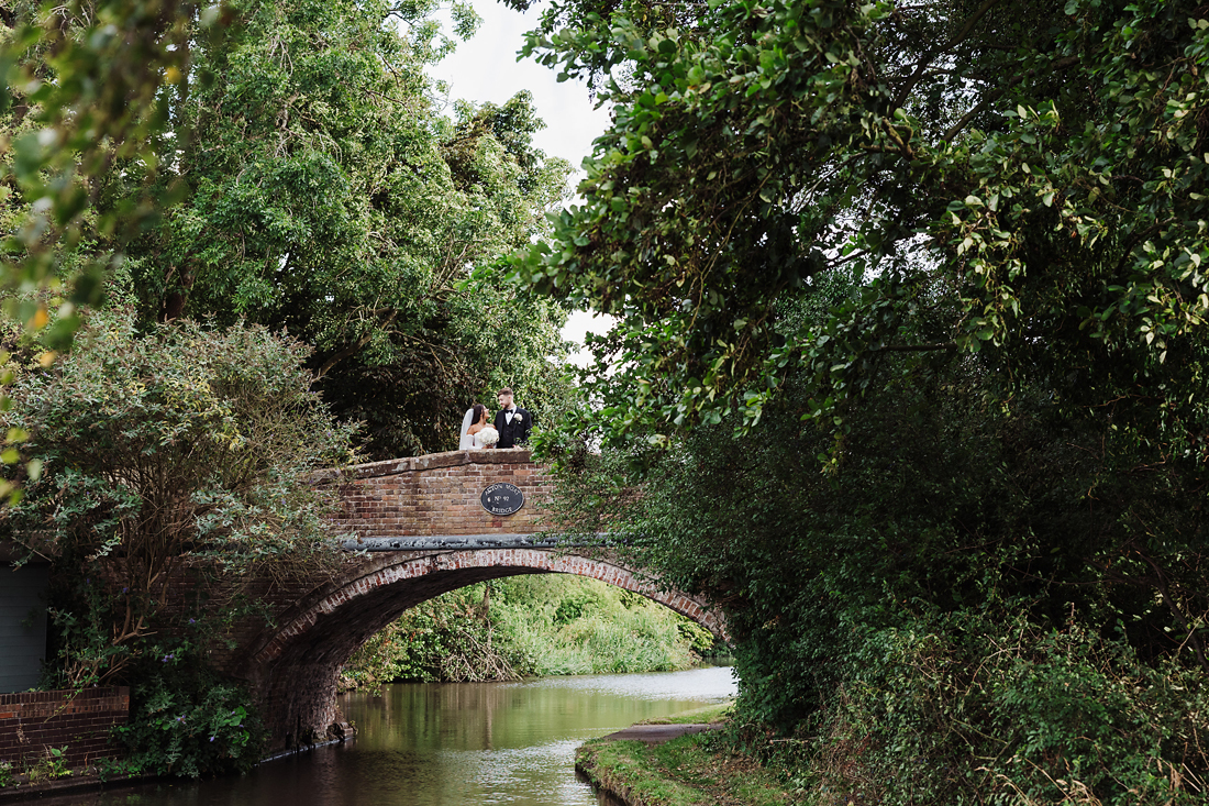 Bride and groom having relaxed wedding portraits during the drinks reception