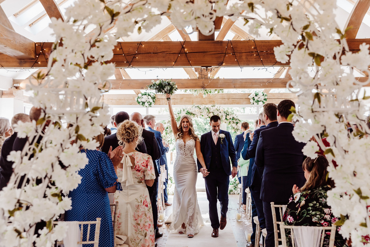 Bride and groom take first walk together at Blithfield Lakeside Barns