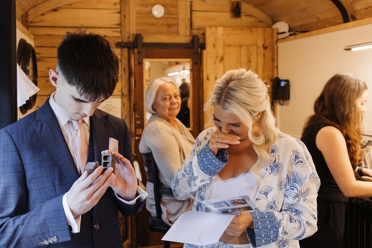 Nikki opening a card from Marcus on the morning of her wedding at The Hundred House Hotel