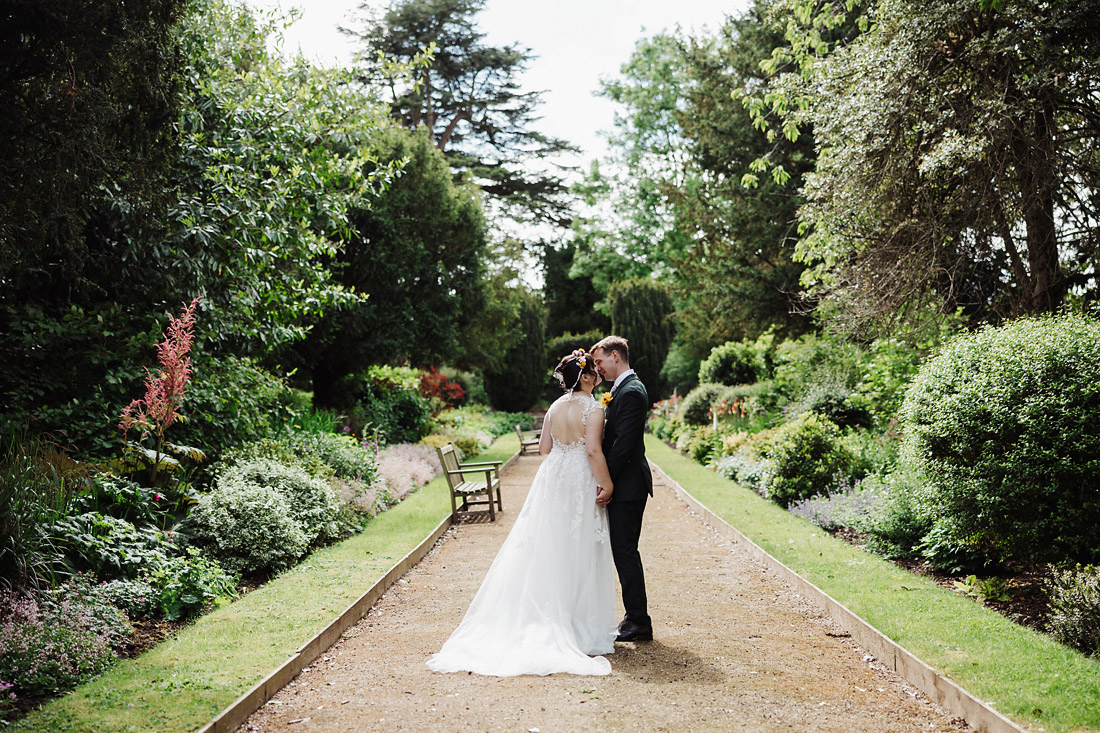 Bride and Groom kiss in the garden at the orangery, ingestre