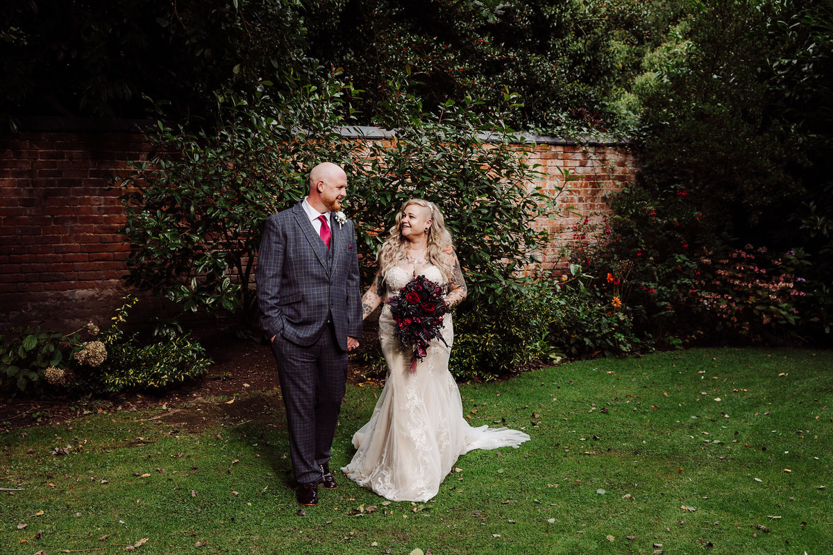 Bride and Groom walk in the gardens at Pendrell Hall