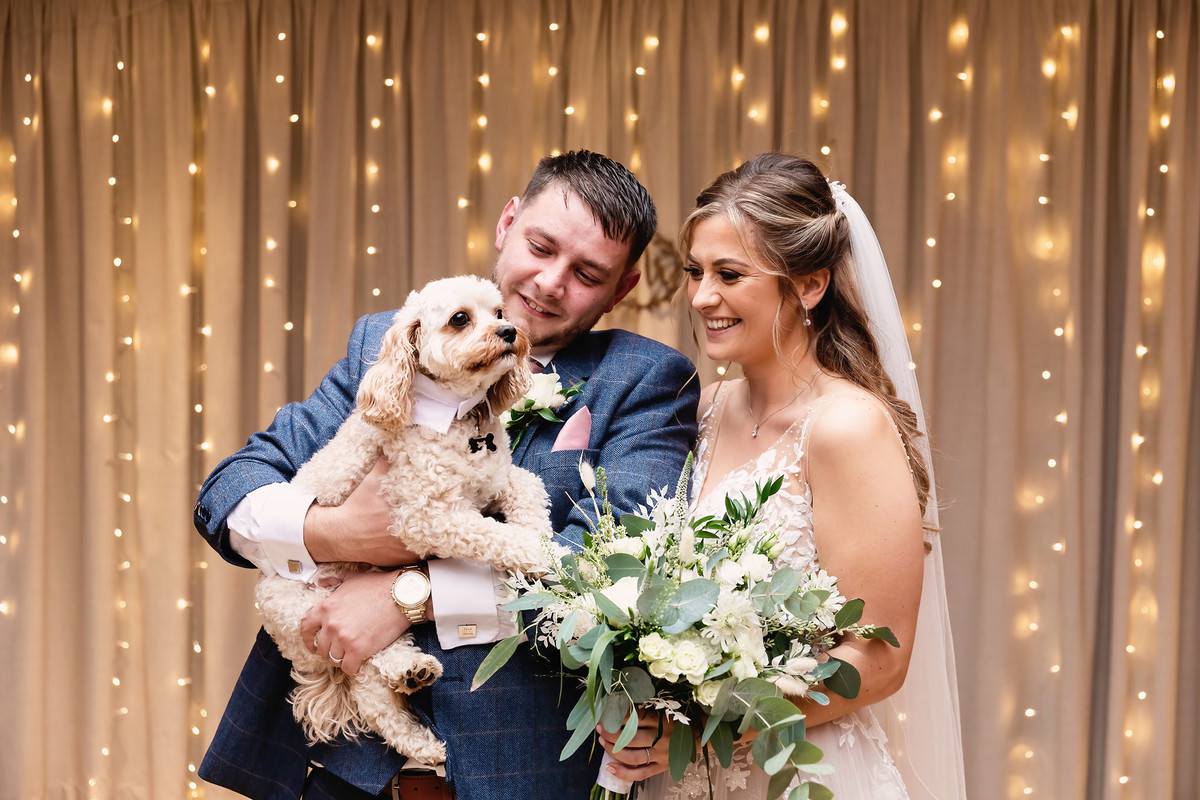 Bride and groom with their dog at Moddershall Oaks