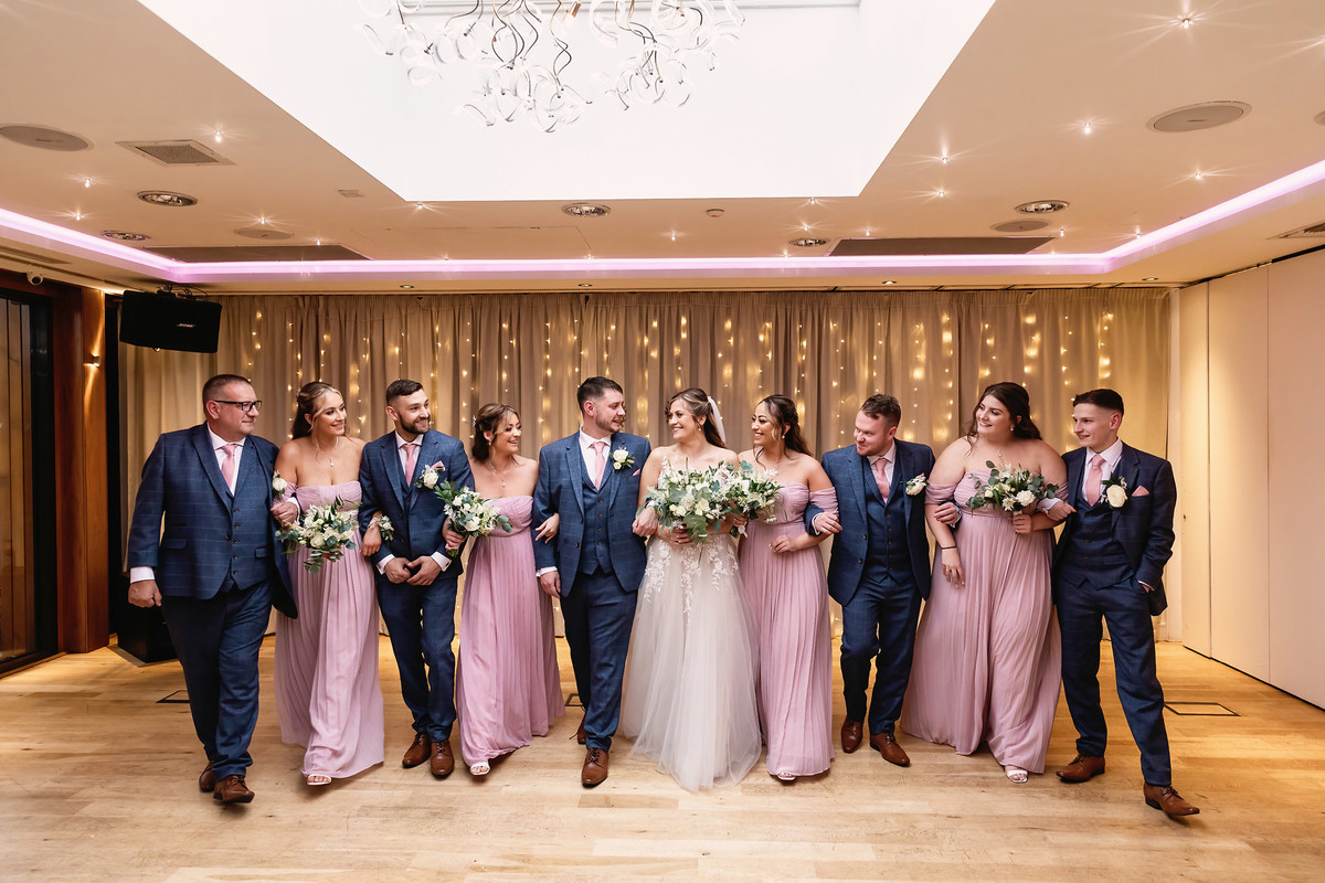Bridesmaids and Groomsmen walking indoors at Moddershall Oaks