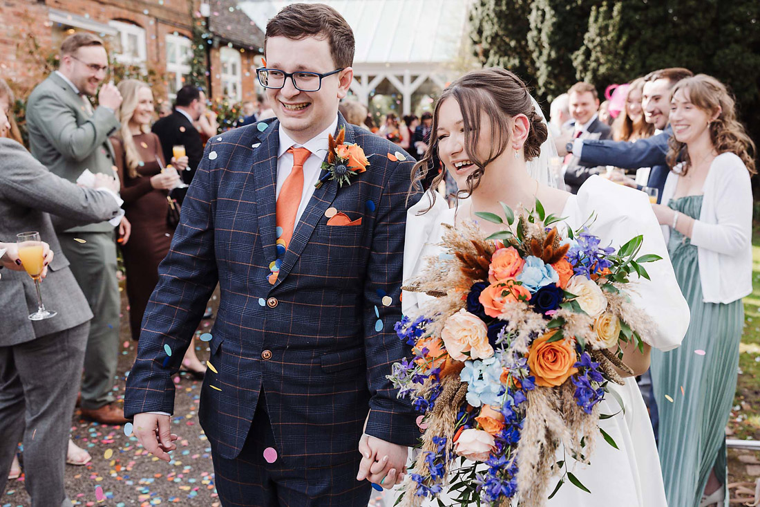 Bride and groom are showered with confetti at The Moat House