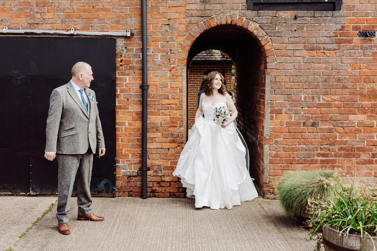 A short stroll to the ceremony for the bride at Hanbury wedding barns