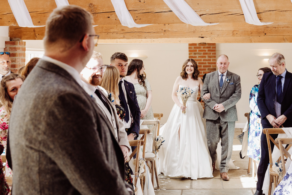 Bride walking down the aisle at Hanbury wedding barns, Staffordshire