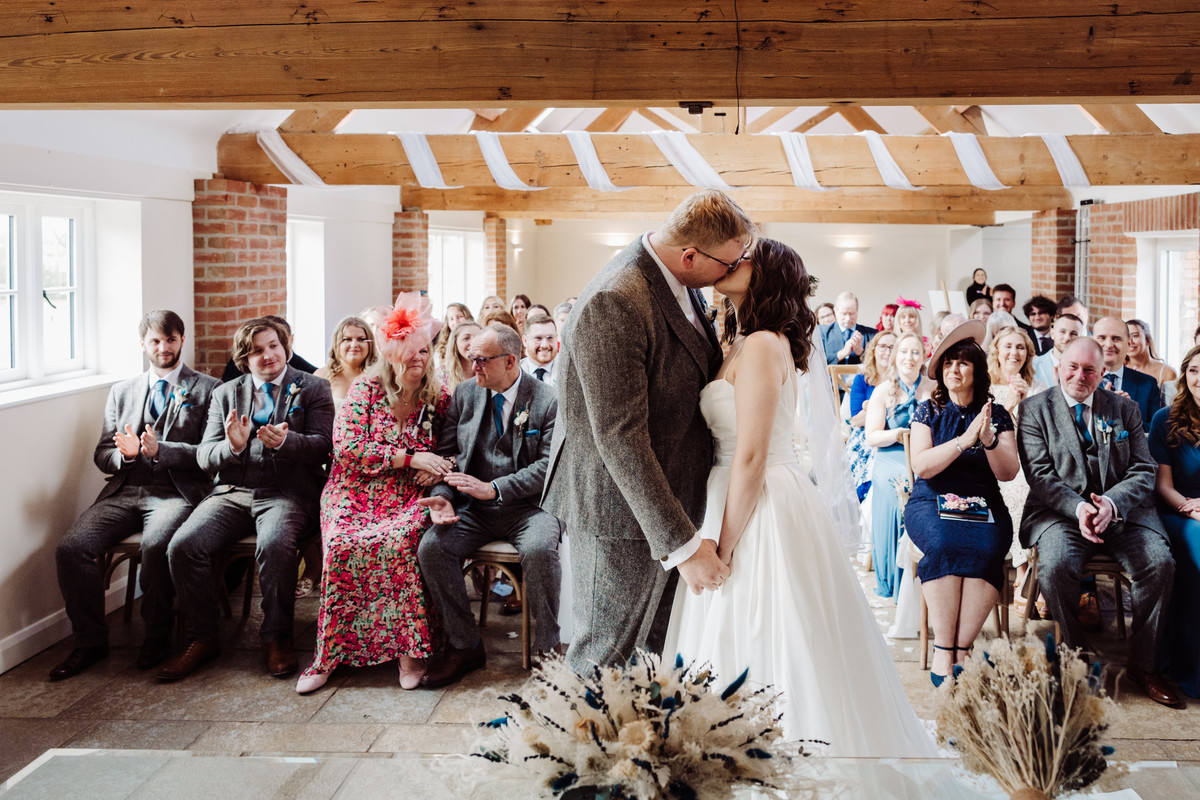 Bride and Groom share their first kiss at Hanbury Wedding Barns