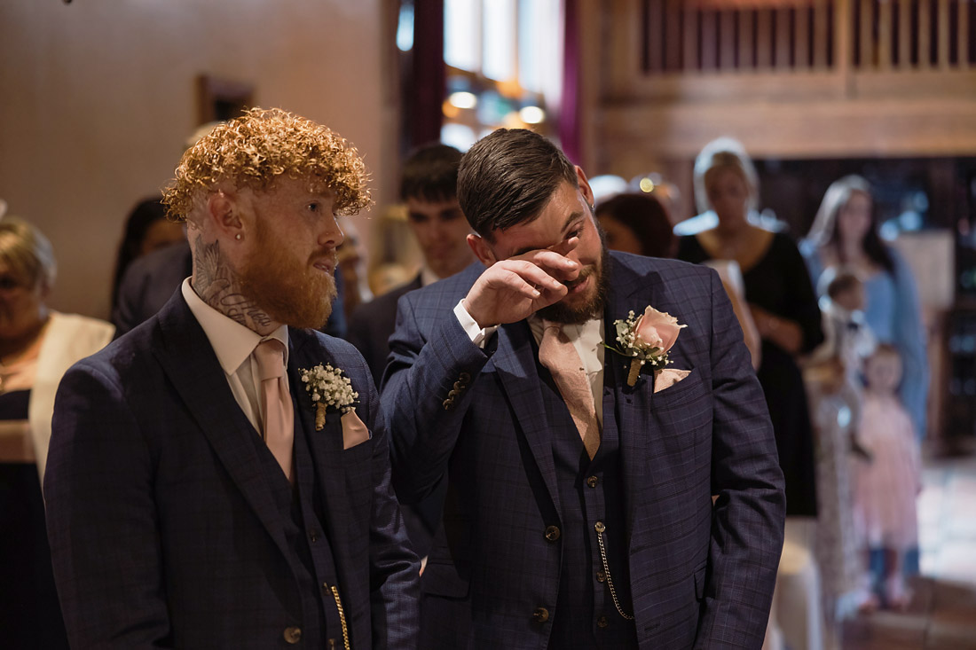 Groom hearing bride's voice over the speaker at The Hundred House Hotel