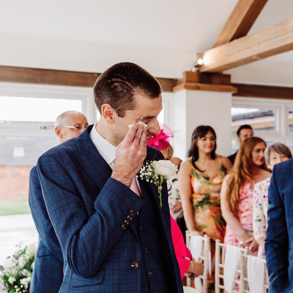 Jodie and Ian seeing each other at the end of the aisle at Blithfield Lakeside Barns