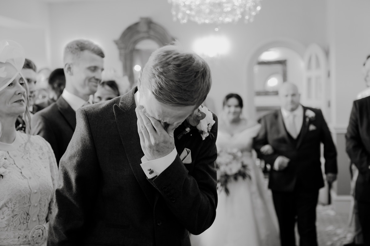 Emotional groom as bride walks down the aisle to him at Weston Hall