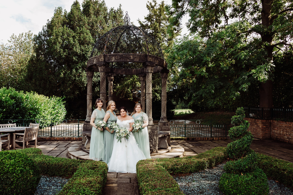 Bride and bridesmaids in the gardens at Weston Hall