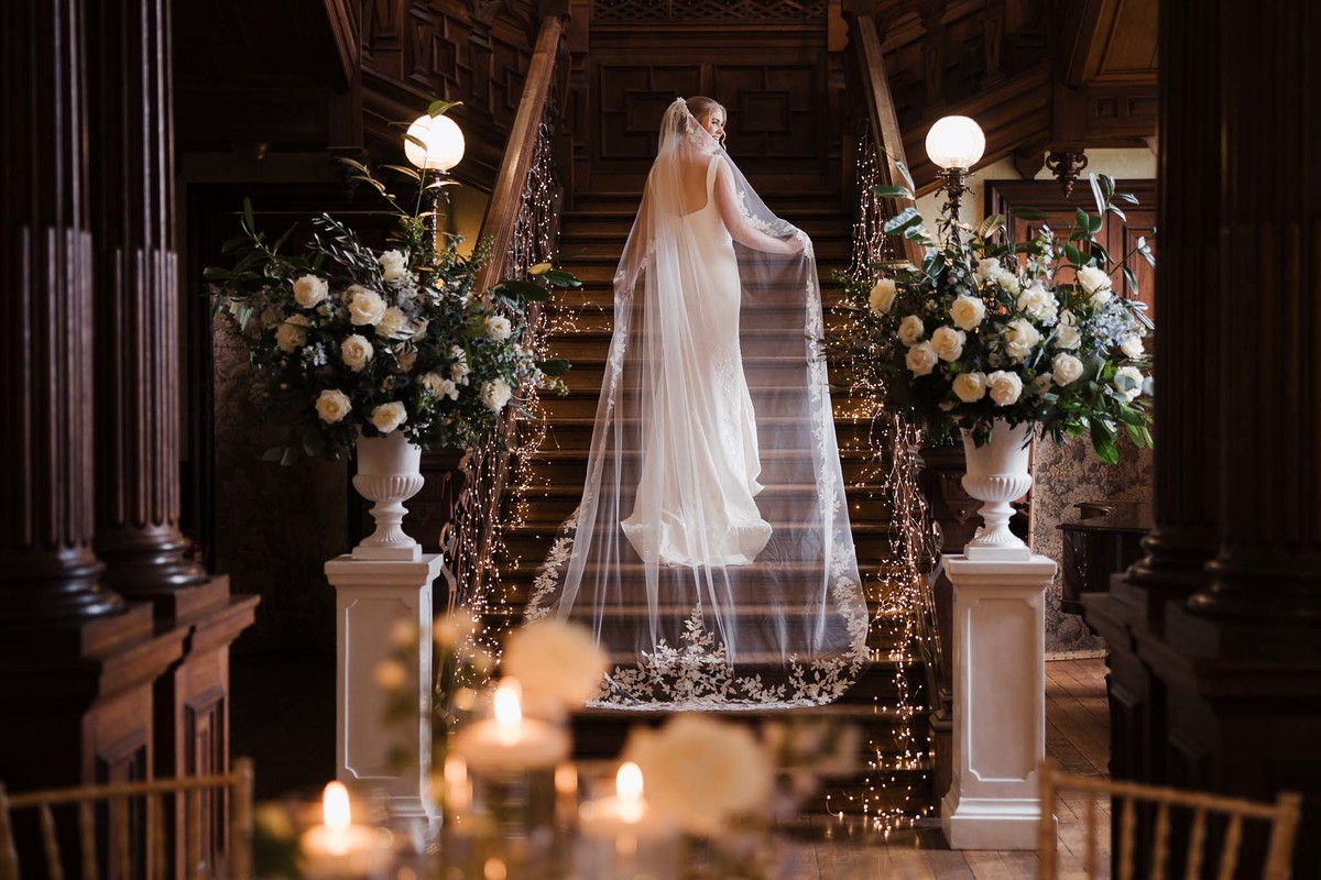 Bride on the grand staircase at Sandon Hall