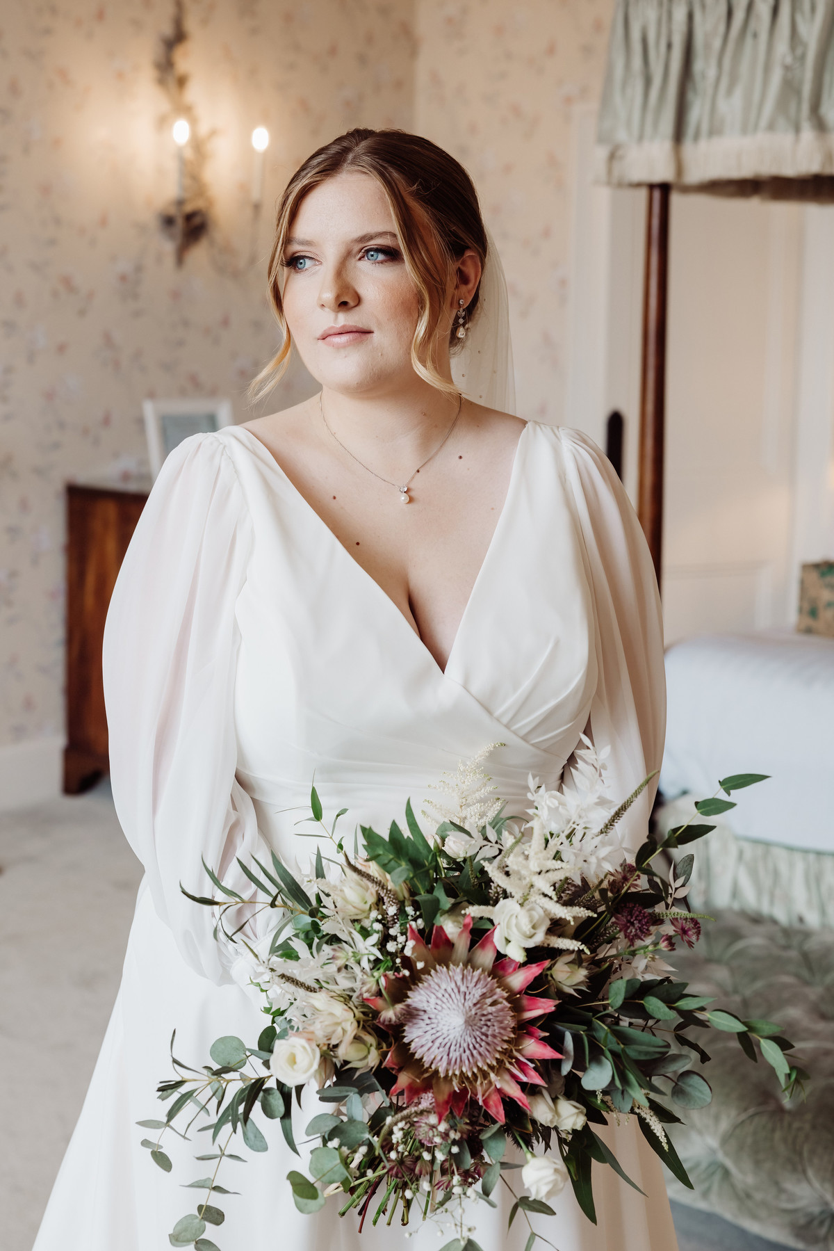 Bride looks thoughtful and reflective before the ceremony at Sandon Hall