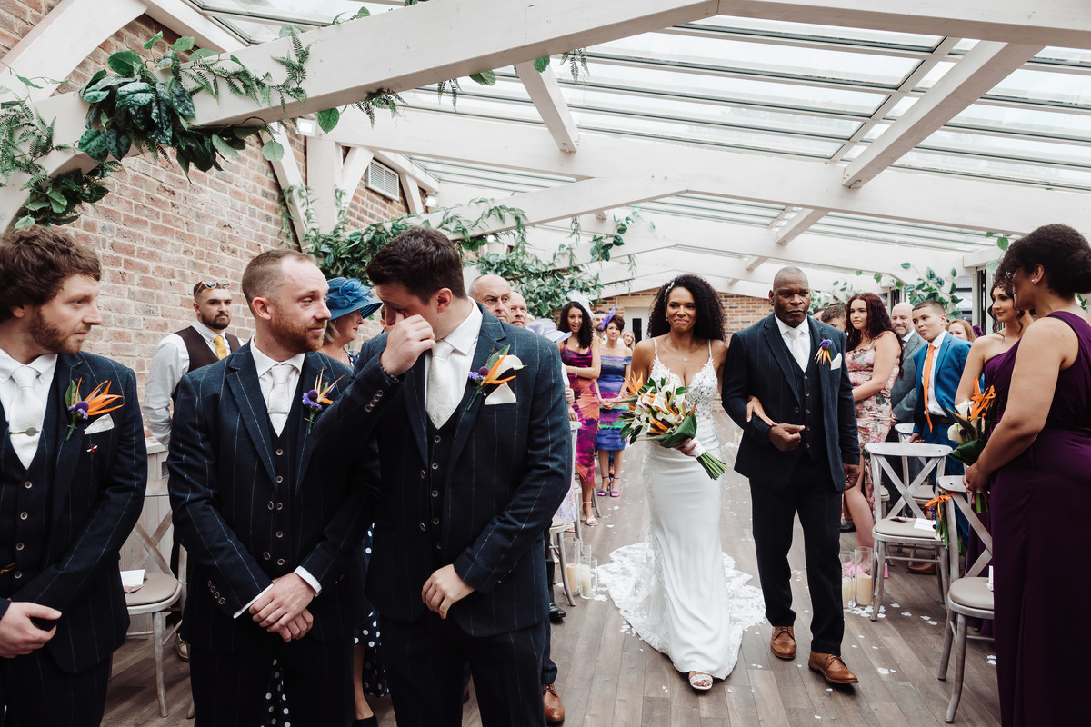An emotional groom wipes a tear at Foxtail Barns Wedding, Staffordshire