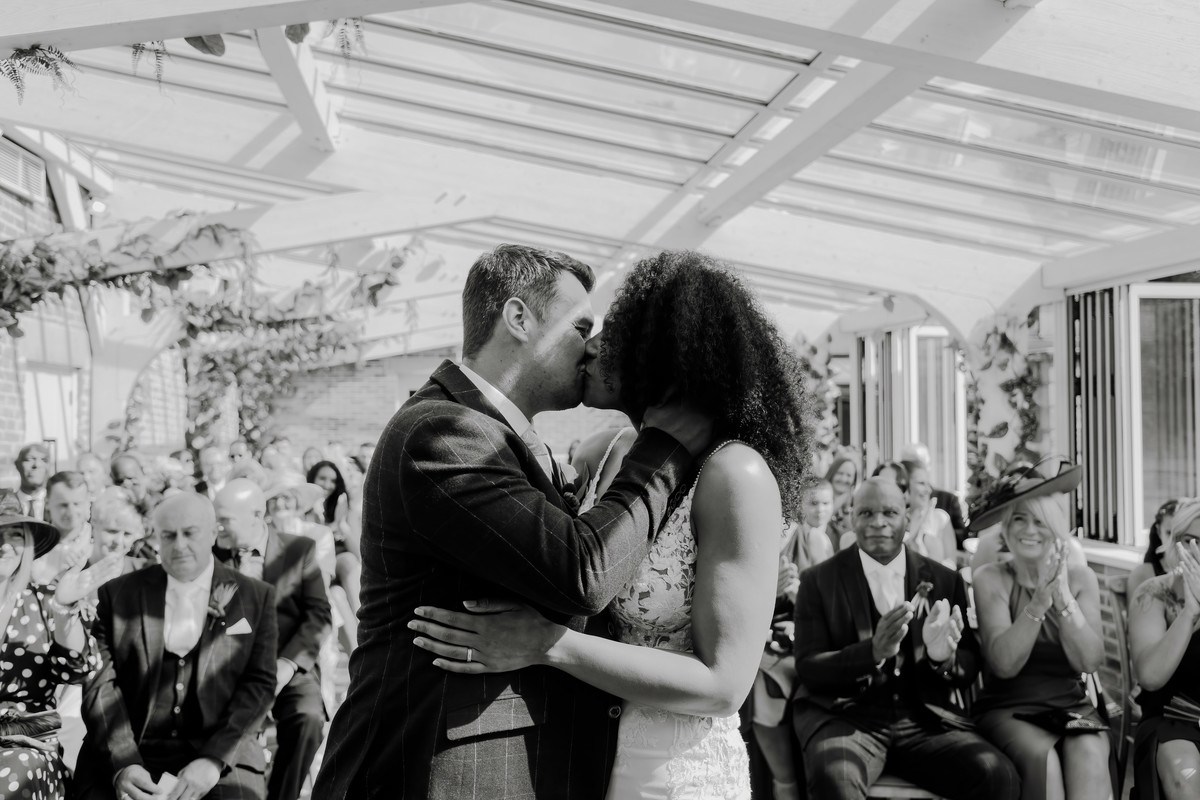 Bride and groom share their first kiss at Foxtail Barns Wedding Venue