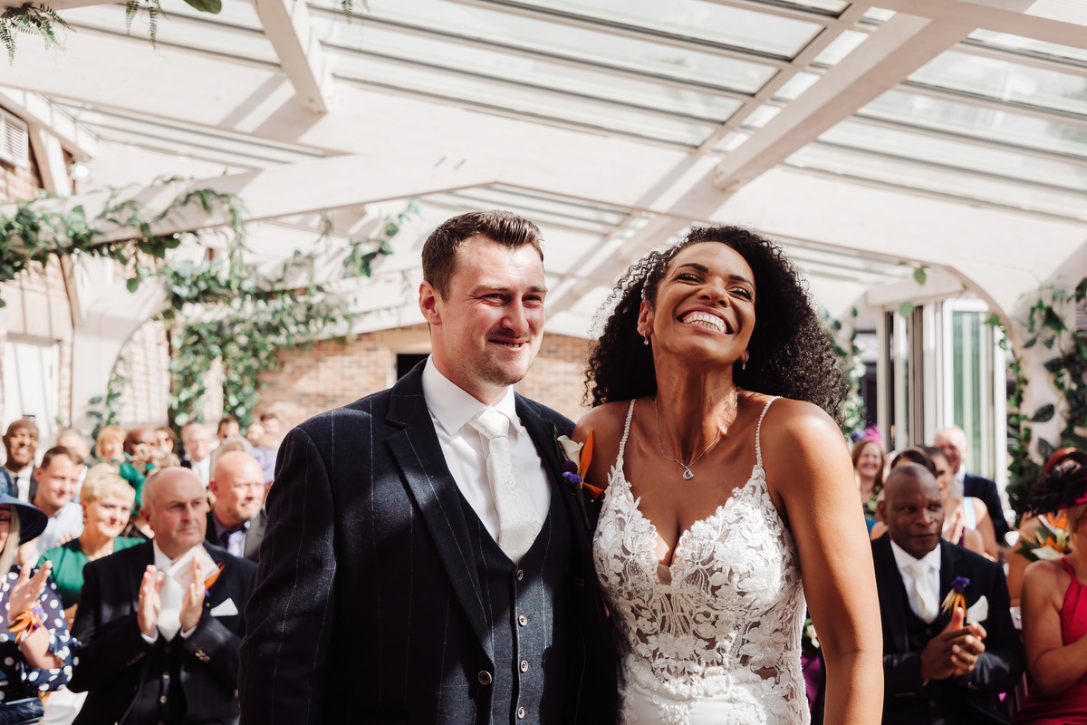 Happy bride and groom share a laugh at foxtail barns ceremony