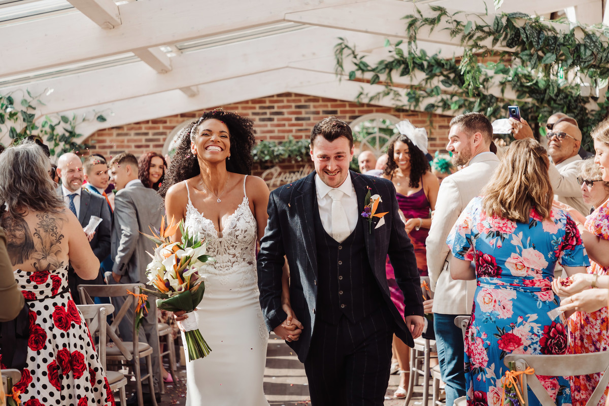 Happy bride and groom leave their foxtail barns ceremony
