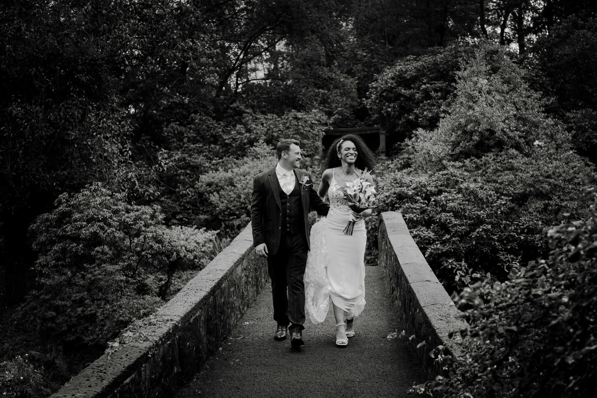 Bride and groom smile despite the rain at Foxtail Barns