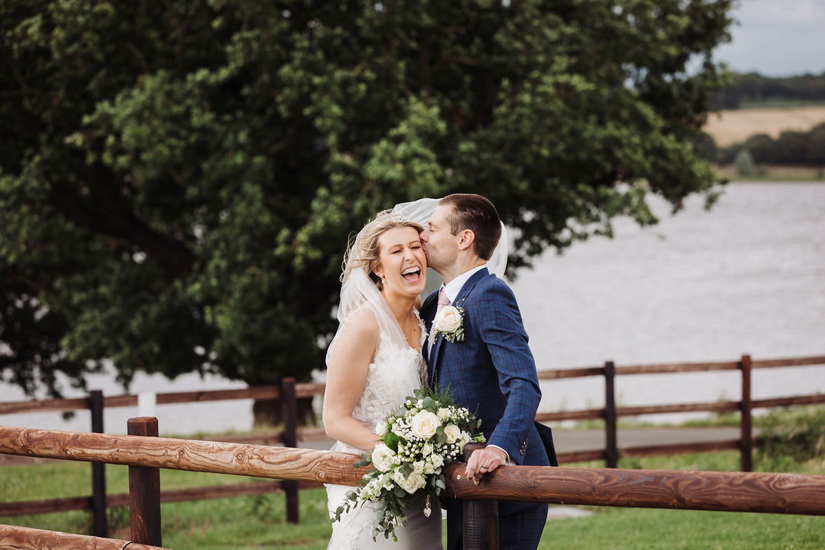Moody skyline portrait of Jodie and Ian at Blithfield Lakeside Barns