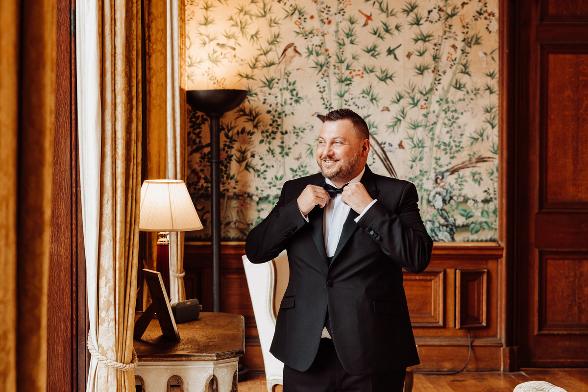 Groom looking smart in the drawing room at Sandon Hall, Staffordshire