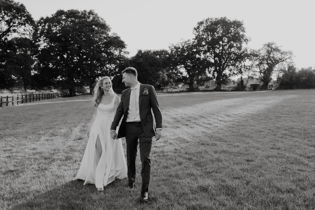 A couple are photographed strolling through a Staffordshire field