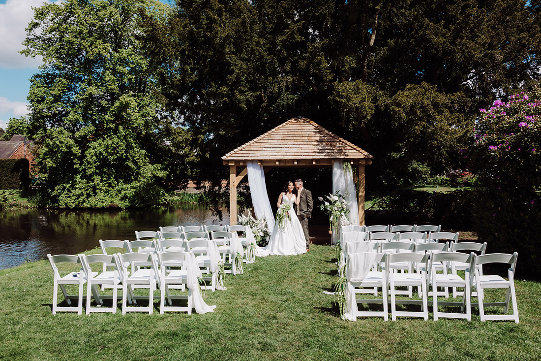 Outdoor ceremony set up by the lake at The Moat House