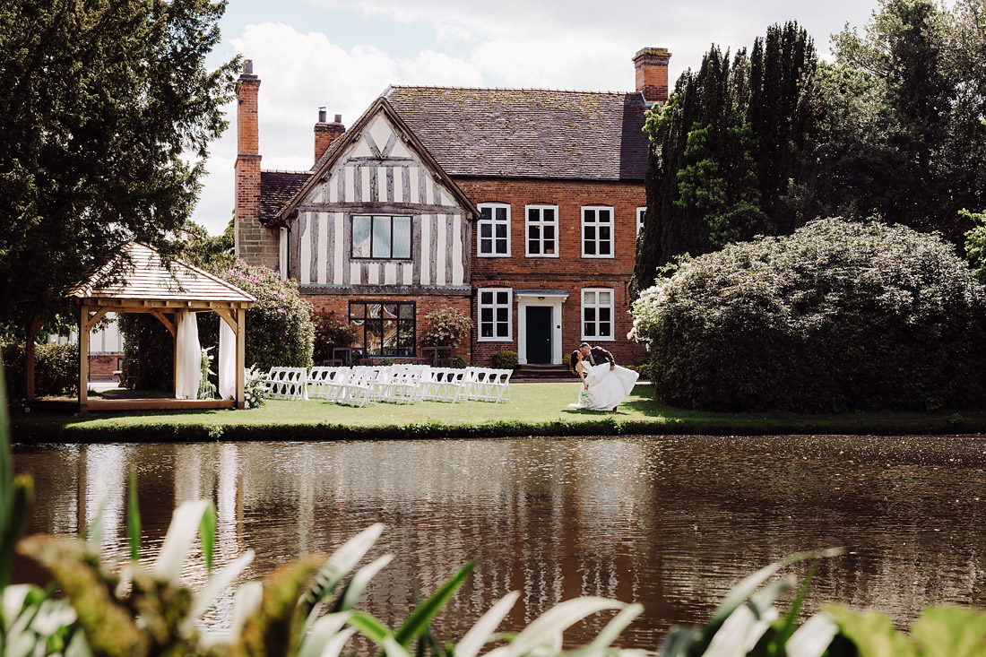 The Moat House wedding venue beside the lake in sunshine