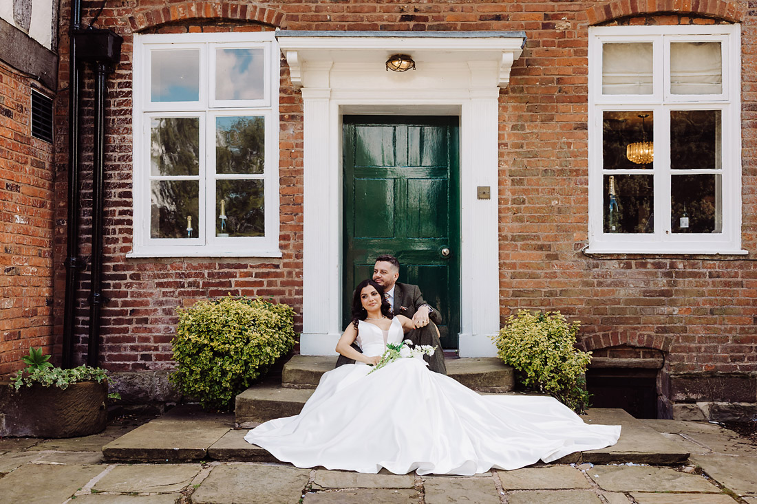Bride and groom portraits by the green door at The Moat House