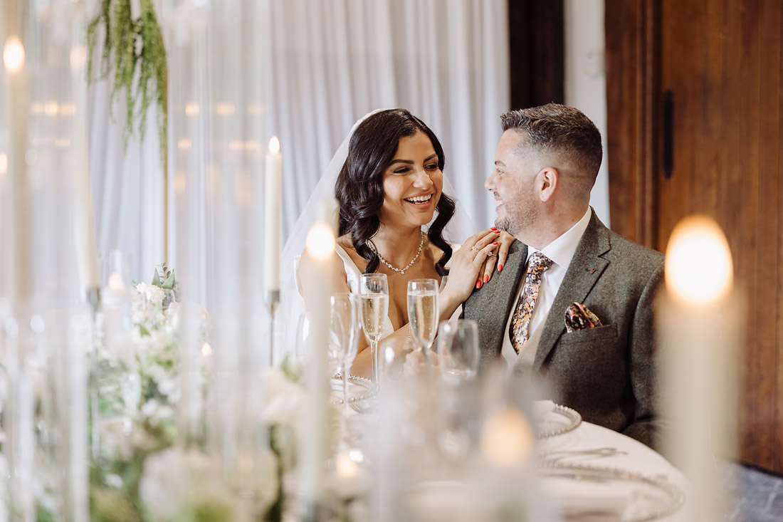 White and green wedding table styling with candles by Sorella