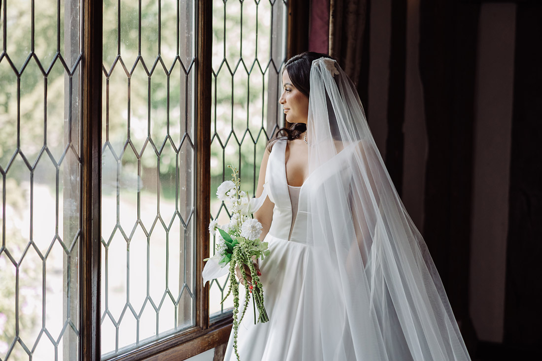 Bride by the window portraits in the Colin Lewis Suite at The Moat House