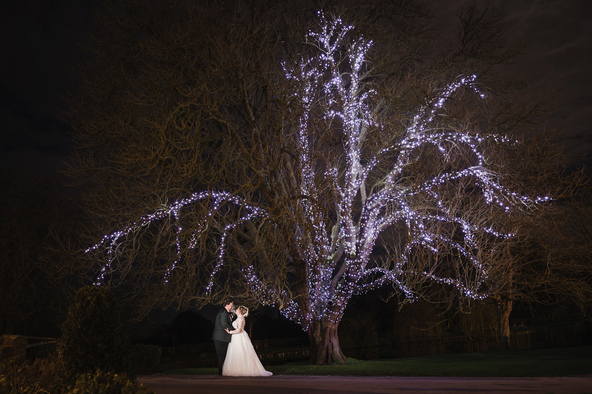 Signature night time wedding portrait with creative lighting after dark