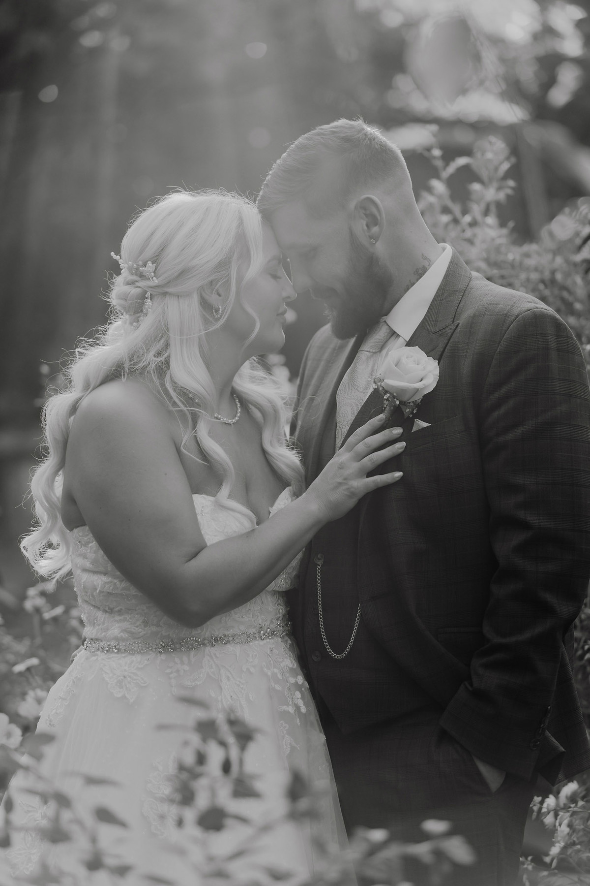 Black and white wedding portrait of Nikki and Dan in the gardens at The Hundred House Hotel