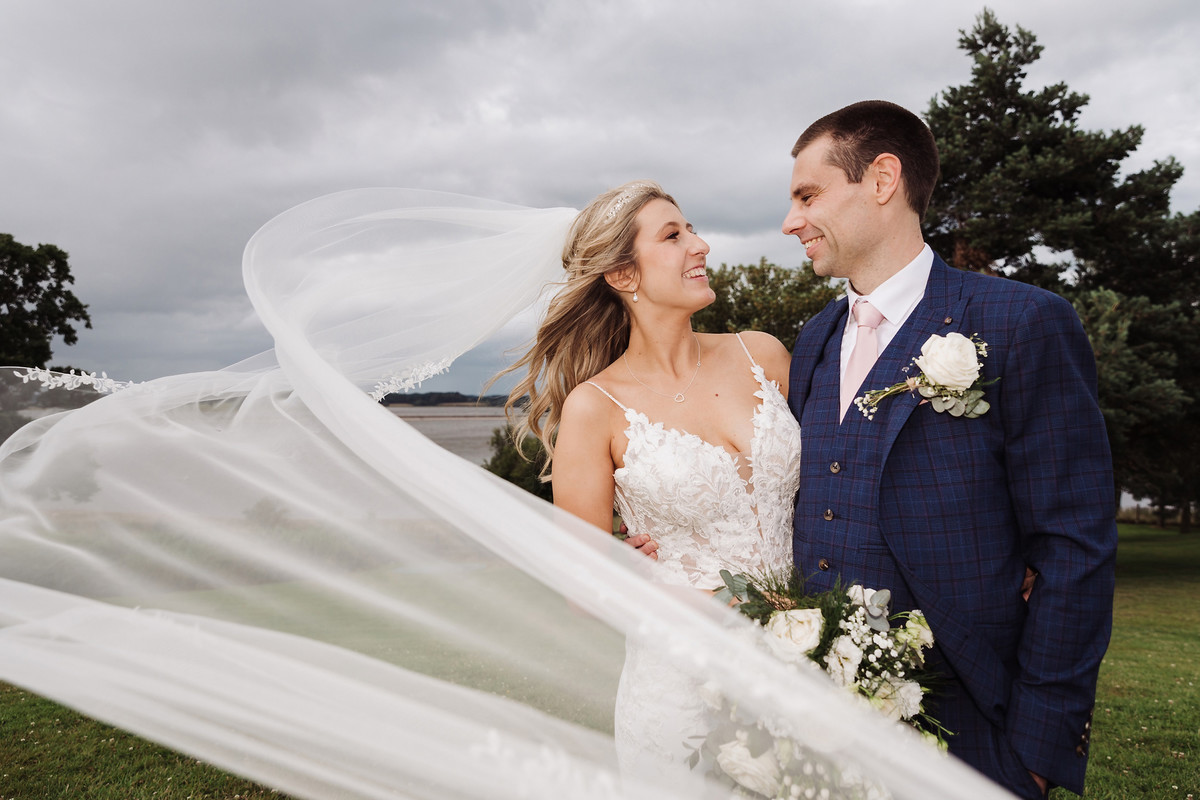 Windy veil photograph of Jodie and Ian at Blithfield Lakeside Barns
